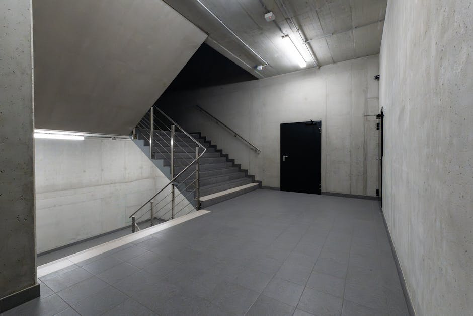 A modern and minimalist concrete stairwell showcasing industrial architecture.